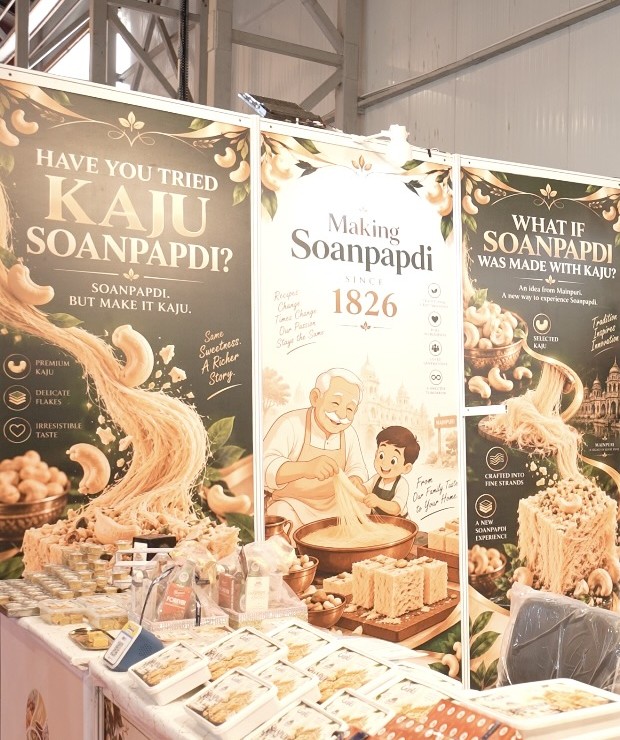Detail of Brijwasi’s Kaju Soanpadi exhibition panels and packaged sweets at UPITS 2026